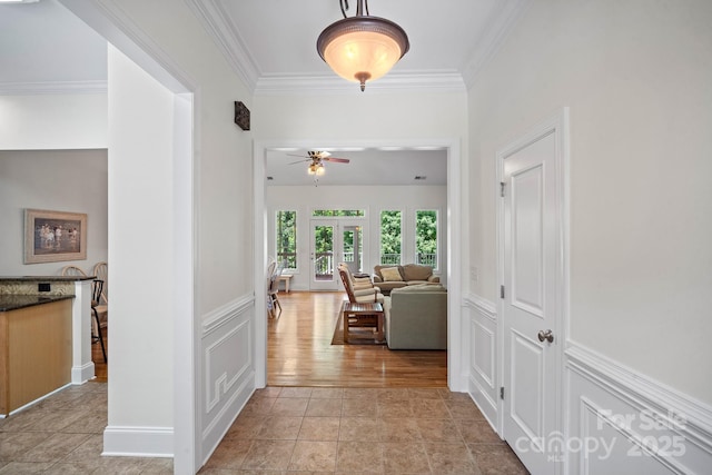 591 Emerald Isle Ct, Lexington, NC 27292 - hall featuring a decorative wall, ornamental molding, a wainscoted wall, and light tile patterned flooring