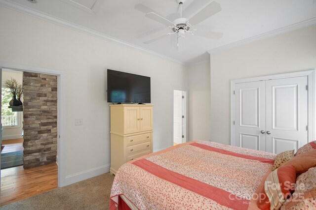 591 Emerald Isle Ct, Lexington, NC 27292 - bedroom with crown molding, ceiling fan, a closet, light carpet, and baseboards