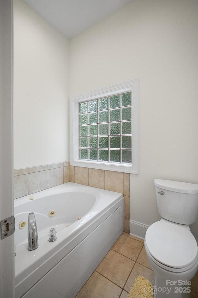 591 Emerald Isle Ct, Lexington, NC 27292 - bathroom with a whirlpool tub, toilet, tile patterned flooring, and baseboards