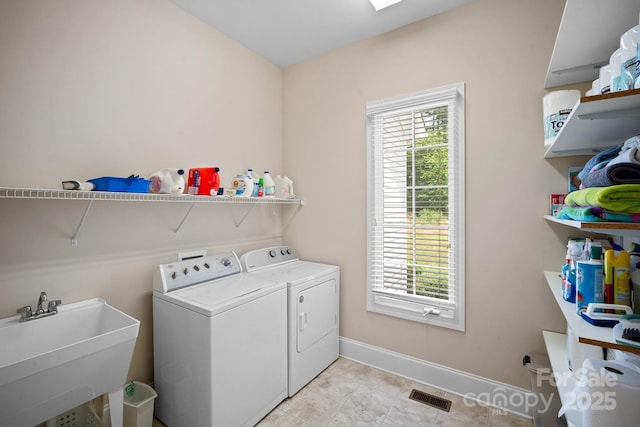 591 Emerald Isle Ct, Lexington, NC 27292 - clothes washing area featuring laundry area, a wealth of natural light, visible vents, a sink, and washer and clothes dryer