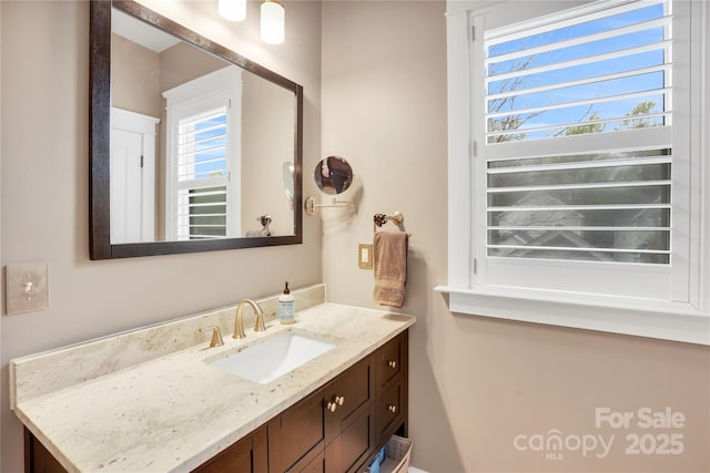 bathroom featuring a wealth of natural light and vanity