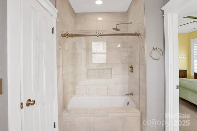 bathroom featuring recessed lighting, tiled shower / bath combo, and connected bathroom