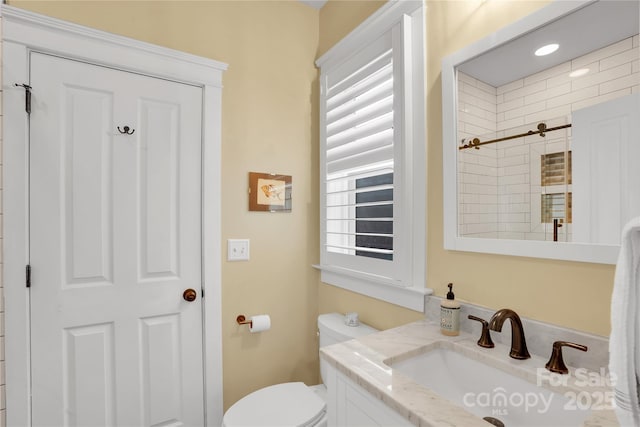 bathroom featuring toilet and vanity