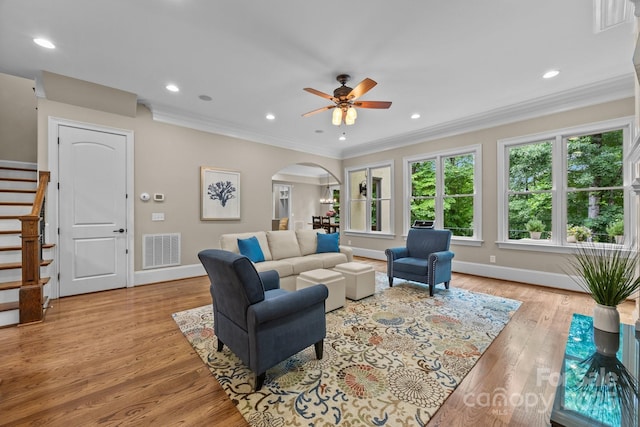 914 Elizabeth Ln, Matthews, NC 28105 - living area with arched walkways, crown molding, stairs, baseboards, and a ceiling fan