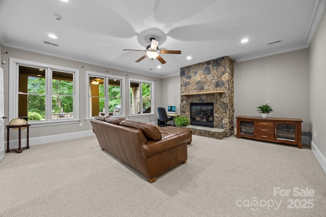 914 Elizabeth Ln, Matthews, NC 28105 - carpeted living room with baseboards, a ceiling fan, ornamental molding, a stone fireplace, and recessed lighting