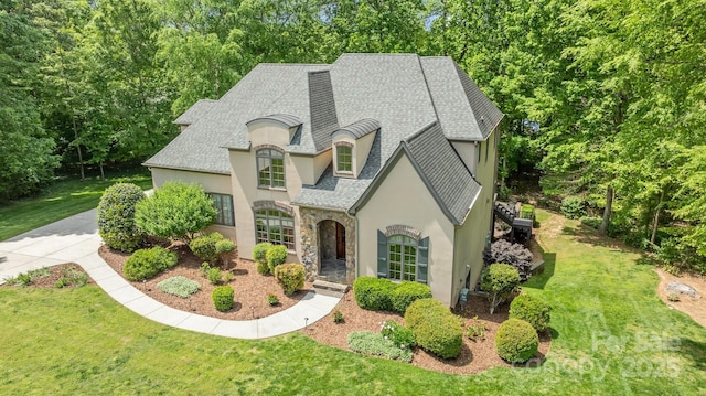 914 Elizabeth Ln, Matthews, NC 28105 - french country style house with stucco siding, stone siding, a front yard, and roof with shingles