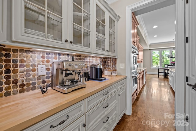 914 Elizabeth Ln, Matthews, NC 28105 - bar area with backsplash, dark wood-type flooring, ornamental molding, and recessed lighting