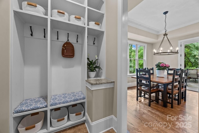 914 Elizabeth Ln, Matthews, NC 28105 - mudroom with a chandelier, wood finished floors, crown molding, healthy amount of natural light, and baseboards