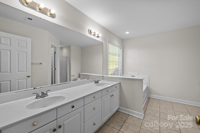 bathroom featuring a sink, visible vents, tile patterned floors, and double vanity