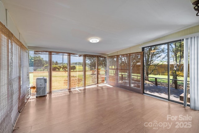 unfurnished sunroom featuring wood finished floors