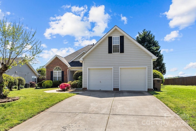 traditional-style house featuring a garage, a front yard, brick siding, and concrete driveway