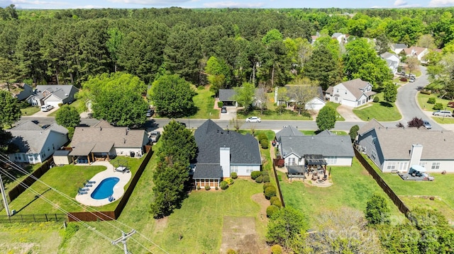 bird's eye view with a wooded view and a residential view