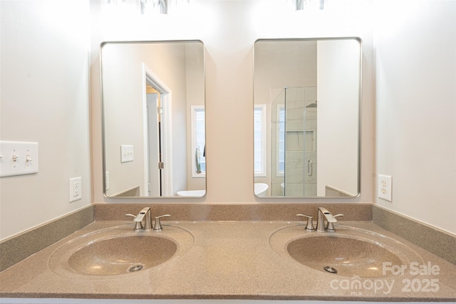 full bath featuring double vanity, a shower stall, and a sink