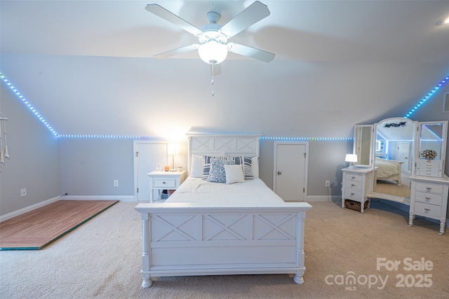 bedroom with a ceiling fan, baseboards, vaulted ceiling, and light colored carpet