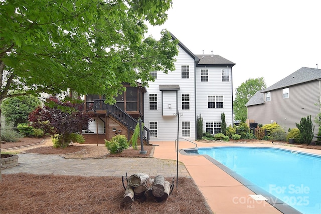 pool with stairway and a patio area