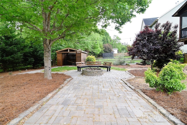 view of property's community with an outdoor structure and an outdoor fire pit