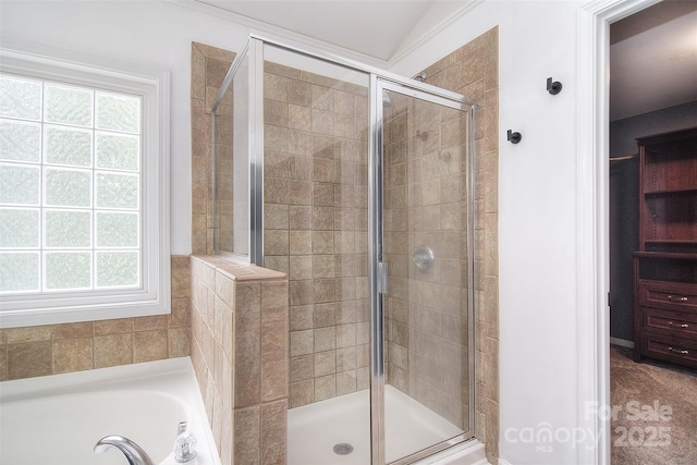 bathroom featuring a bathtub and a shower stall