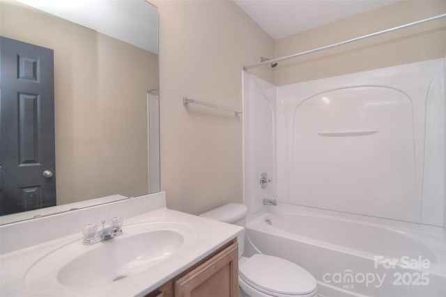 bathroom featuring shower / washtub combination, vanity, and toilet