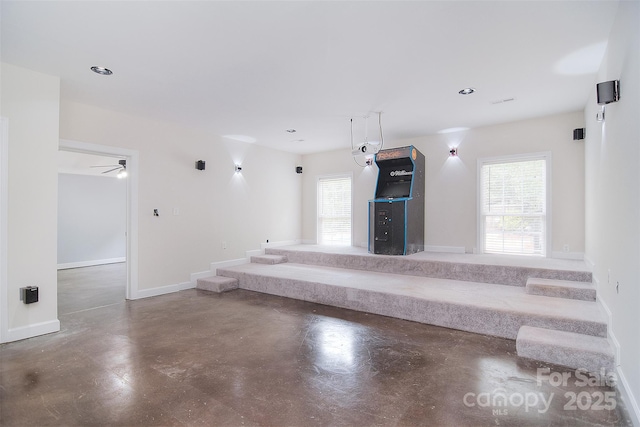 interior space featuring concrete floors, baseboards, and recessed lighting