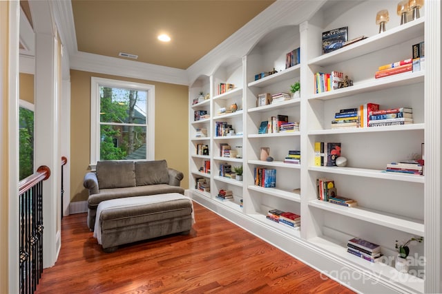 sitting room with baseboards, wood finished floors, and visible vents