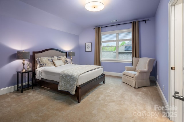 bedroom with carpet floors, baseboards, and visible vents