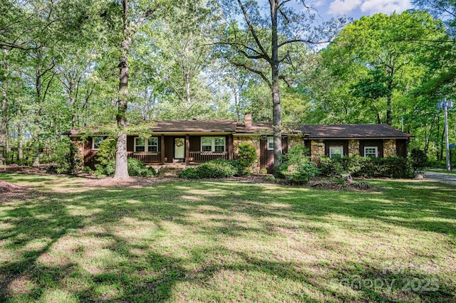 2415 Hargette Rd, Monroe, NC 28112 - ranch-style home featuring a front lawn, covered porch, and a chimney