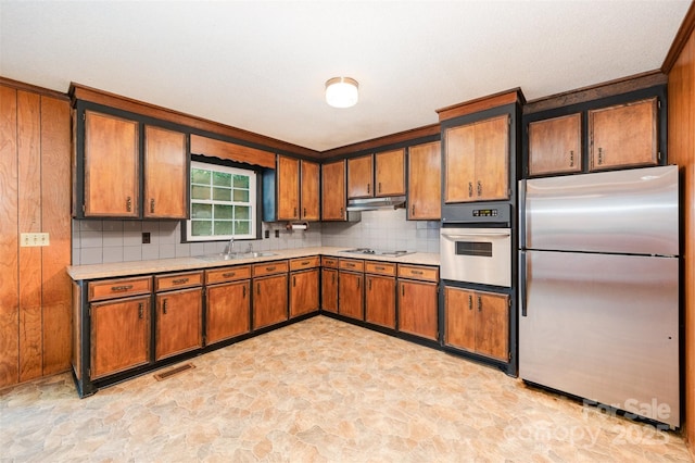 2415 Hargette Rd, Monroe, NC 28112 - kitchen with visible vents, freestanding refrigerator, wall oven, under cabinet range hood, and stone finish flooring
