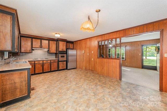 2415 Hargette Rd, Monroe, NC 28112 - kitchen with a sink, light countertops, appliances with stainless steel finishes, brown cabinetry, and stone finish flooring