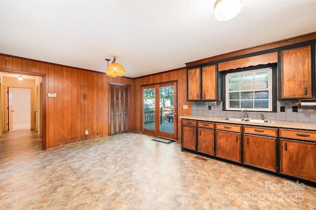 2415 Hargette Rd, Monroe, NC 28112 - kitchen featuring tasteful backsplash, a sink, light countertops, brown cabinets, and stone finish flooring