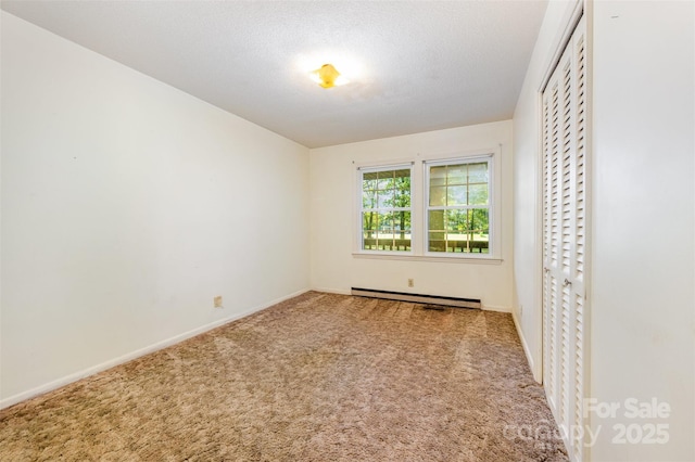 2415 Hargette Rd, Monroe, NC 28112 - spare room featuring a baseboard heating unit, baseboards, and carpet flooring