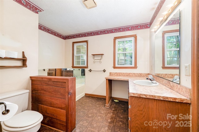 2415 Hargette Rd, Monroe, NC 28112 - bathroom with vanity, baseboards, tile patterned floors, toilet, and a garden tub