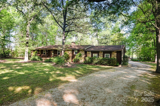 2415 Hargette Rd, Monroe, NC 28112 - single story home featuring stone siding, a front lawn, and dirt driveway