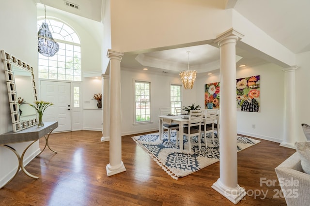 108 Tall Oak Dr, Mooresville, NC 28117 - entryway featuring crown molding, ornate columns, visible vents, wood finished floors, and a notable chandelier