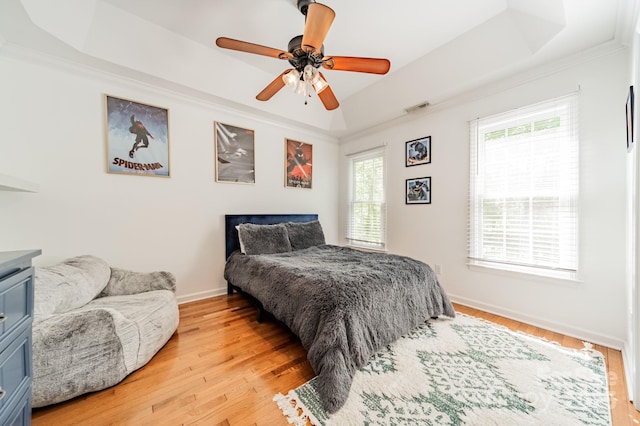 108 Tall Oak Dr, Mooresville, NC 28117 - bedroom featuring visible vents, baseboards, a raised ceiling, crown molding, and light wood-style flooring