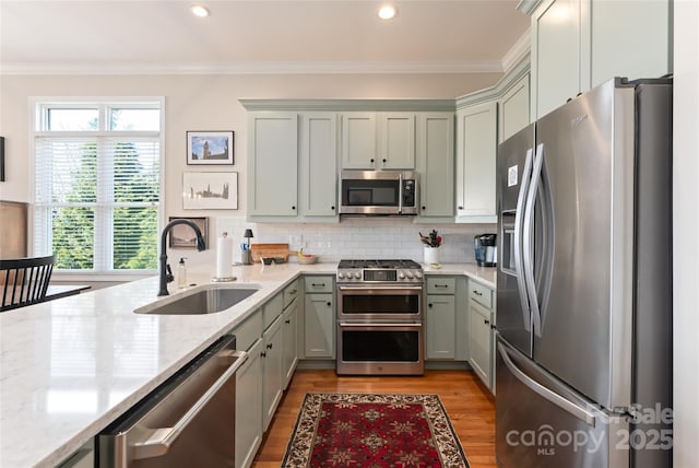116 Dalya Rd, Swannanoa, NC 28778 - kitchen with stainless steel appliances, light wood-type flooring, light stone countertops, tasteful backsplash, and crown molding