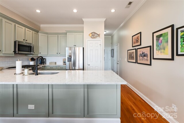 116 Dalya Rd, Swannanoa, NC 28778 - kitchen with stainless steel appliances, a peninsula, gray cabinets, light stone counters, and backsplash