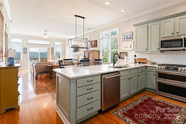 116 Dalya Rd, Swannanoa, NC 28778 - kitchen with appliances with stainless steel finishes, gray cabinets, ceiling fan, a peninsula, and ornamental molding