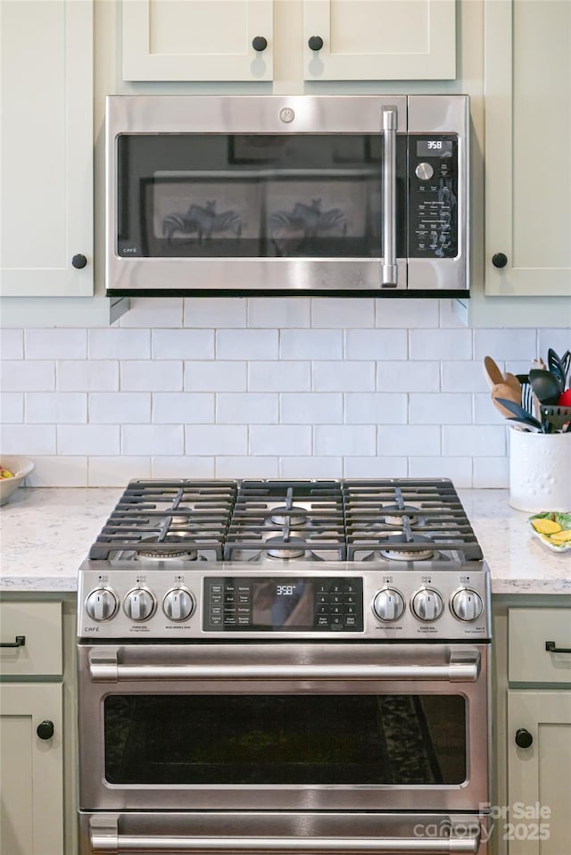 116 Dalya Rd, Swannanoa, NC 28778 - kitchen featuring appliances with stainless steel finishes, backsplash, and light stone countertops