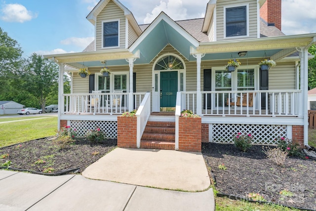 view of front of house with covered porch and a chimney