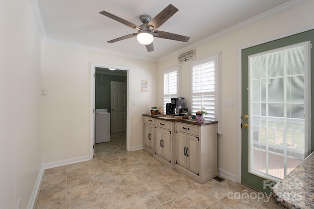 kitchen featuring washer / dryer, ceiling fan, ornamental molding, dark countertops, and baseboards