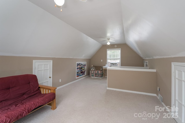 sitting room featuring a ceiling fan, lofted ceiling, carpet floors, and baseboards