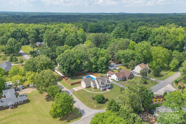 view of property location featuring a forest