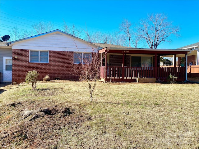 1410 Delwood Dr SW, Lenoir, NC 28645 - view of front facade featuring a front yard, brick siding, and covered porch