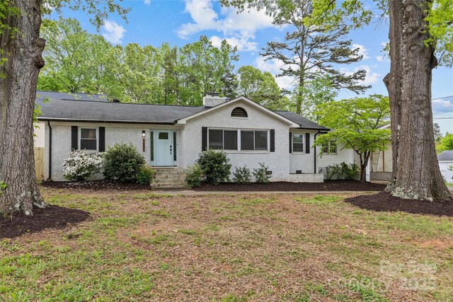 1601 Gambia St, Charlotte, NC 28208 - ranch-style home featuring a chimney, a shingled roof, a front yard, and brick siding