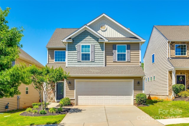 view of front facade featuring board and batten siding, an attached garage, driveway, and a shingled roof