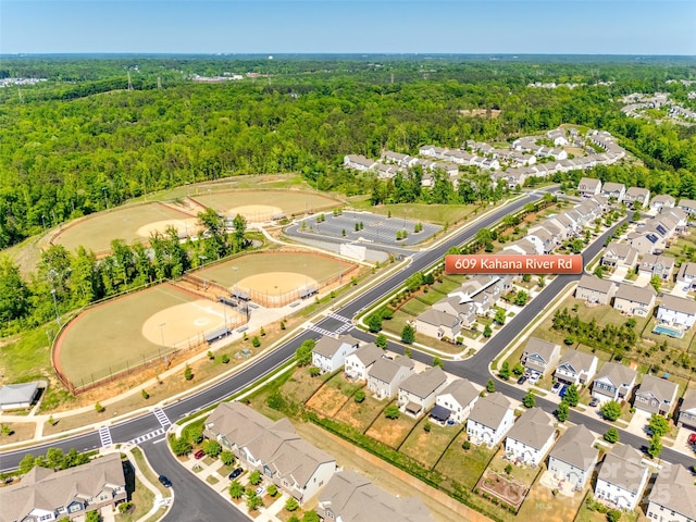 bird's eye view featuring a forest view and a residential view