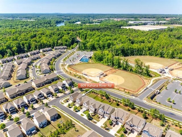 drone / aerial view featuring a wooded view