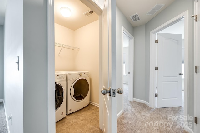 laundry area featuring laundry area, visible vents, and washing machine and clothes dryer
