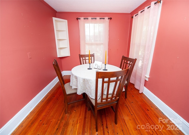 dining room featuring baseboards and hardwood / wood-style floors