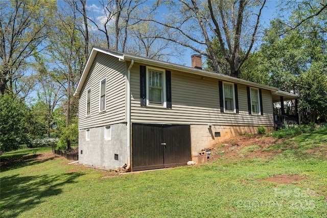view of property exterior with a yard and a chimney